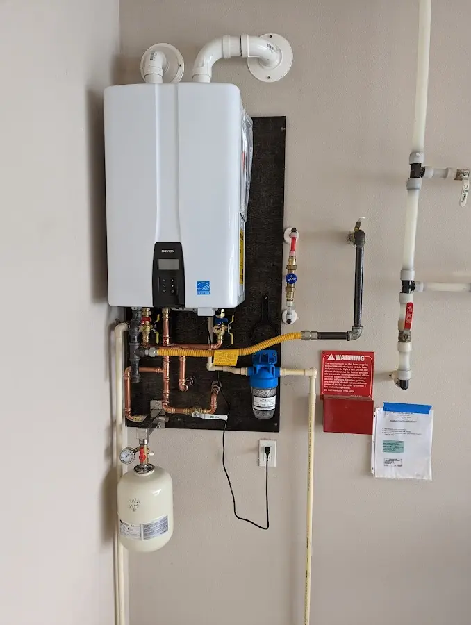 Professional plumber installing copper piping in a Millbrae home